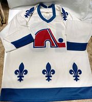 Front view of jersey showing Nordiques logo, collar, sleeve and waist details