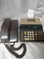 Telephone and calculator side by side