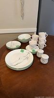 Dinnerware pieces stacked on table showing pattern and counts