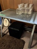 Front view showing entire glass top desk with metal frame