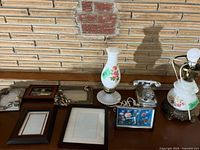 Overall lot showing both lamps, desk clock, telephone paperweight and empty frames