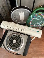 Stool seat, portable heater, additional appliances visible