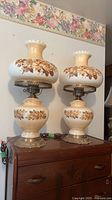 Both lamps on dresser showing size and matching design