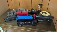 Group shot of locomotive, cars, track, transformer, semaphore, accessory