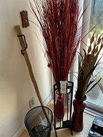 Overall view of items: reeds, walking stick, fireplace stand, vase, waste basket