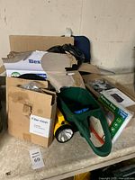 Lot overview showing spreader, flashlight, boxes