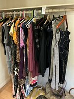 Closet rod with garments on hangers showing variety and quantity