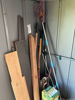 Overall view showing lumber, yard tools, sprayer box