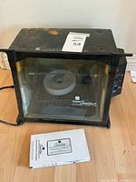 Full view of rotisserie oven with manual