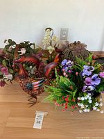 Group shot of roosters, lantern, and faux florals