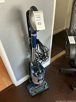 Full view of Shark UV700 upright vacuum showing handle, cord, and base