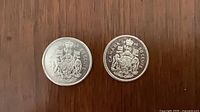 Both 1964 and 1966 Canadian 50 cent coins obverse showing coat of arms