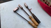 Three soldering irons laid out showing overall form and handles