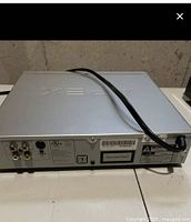 Rear view of Apex AD-1110W showing composite, audio, coaxial and S-Video ports and power cord