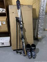 Full view of skis, boots and poles
