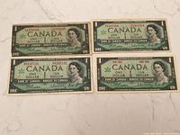 Front view of four 1967 Centennial one-dollar notes