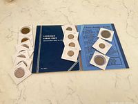 Closed Whitman folder with coin flips containing assorted coins