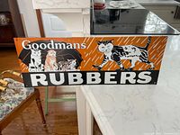 Full view of Goodmans Rubbers sign front displaying graphics and text