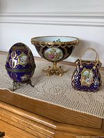 Pedestal bowl, egg trinket box on stand, purse trinket box displayed together
