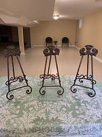 Full view of all three matching cast brass easels on table