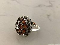 Ring top view showing double halo red stones and marcasite border