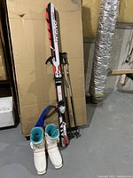 Full lot view showing skis, poles, boots together