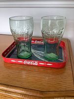 Tray and two tumblers on wooden surface