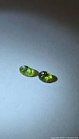Pair of oval-cut apple green peridots