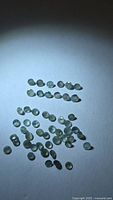 Grouped view of round alexandrite stones under spotlight