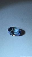 Oval cut bluish-purple tanzanite angled view