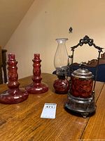 Full lot showing pickle castor, oil lamp, pair candlesticks
