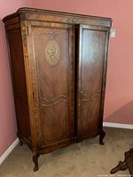 Front angled view of wardrobe showing right side, painted floral panel, veneer pattern, legs