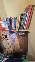 Shelf containing 13 art books plus oversized Klimt publication