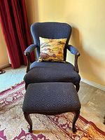 Front view of armchair, ottoman, pillow