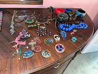 All jewelry laid out on dresser showing variety and count