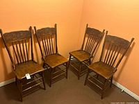 All four matching carved wood chairs front view