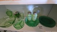 overall lot showing assorted green glassware on shelf