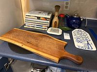 Group shot of cookbooks, boards, teapot and accessories on countertop