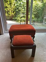 Large and small orange ottomans front view