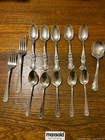 Full set of 13 sterling cutlery pieces laid out