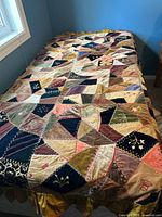 Full view of twin crazy patch quilt on bed