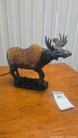 Full view of moose lamp unlit showing resin body and glass shade