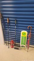 Full lot showing trekking poles, lantern, radio, thermometer, umbrella