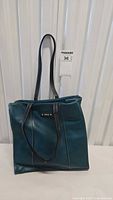 Full view of Roots green-blue tote handbag front