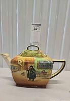 Left side view of Royal Doulton Dickens Ware teapot showing scene and form