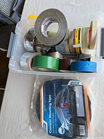 Overview of tub with assorted tape rolls and packaged Camco tape