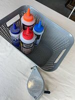 Basket containing four chalk bottles and chalk reel