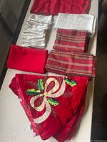Overview of all linens: tree skirt, runner, napkins, tablecloths