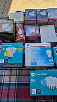 Overview of assorted boxed light bulbs on table