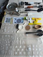 overview of molds and kitchen tools laid on table
